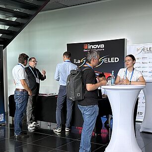 Inova Stand auf der Automotive Lighting Conference 2026 mit Teilnehmern am Netzwerken im Vordergrund
